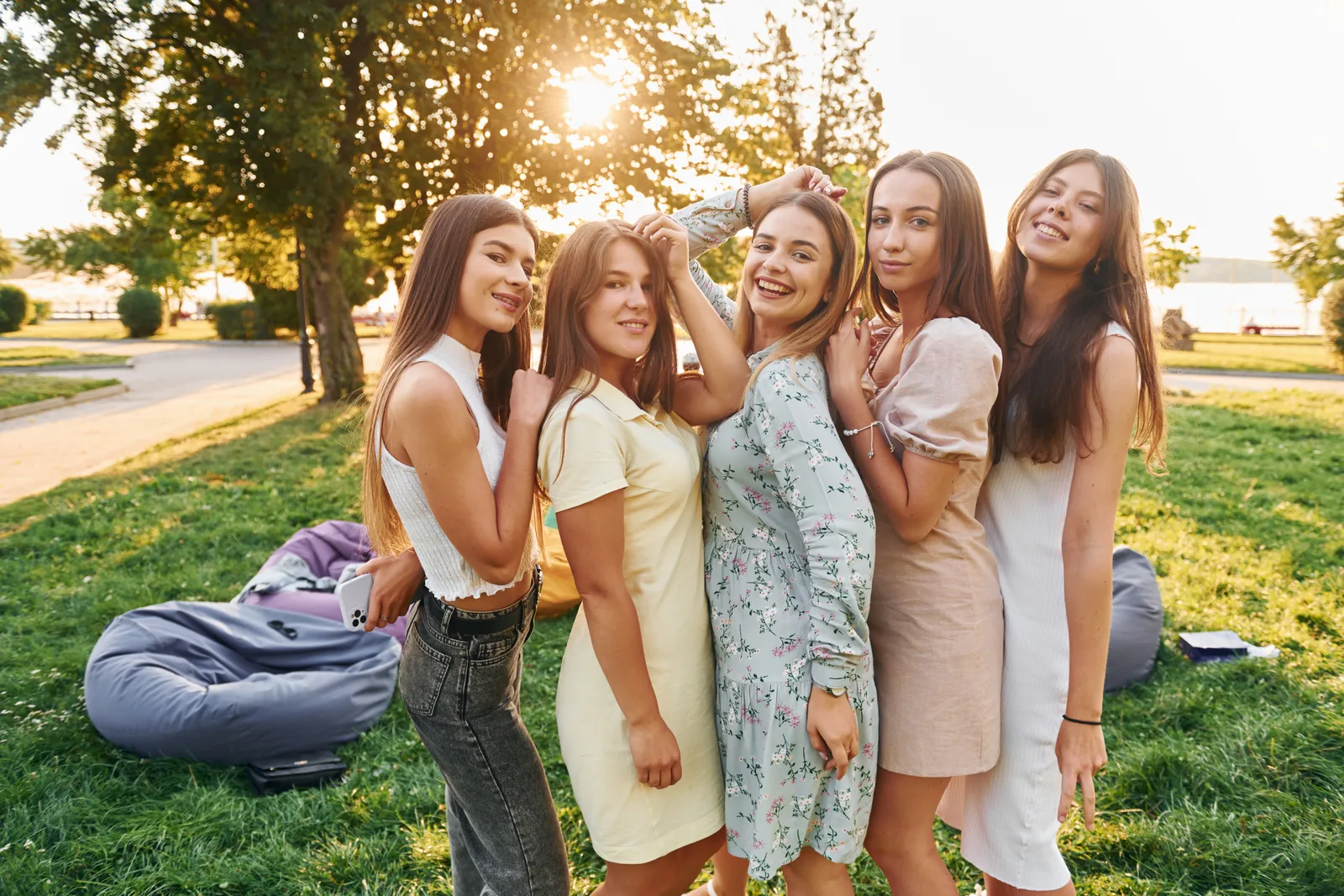 Women's party. Group of young people have fun in the park at summer daytime